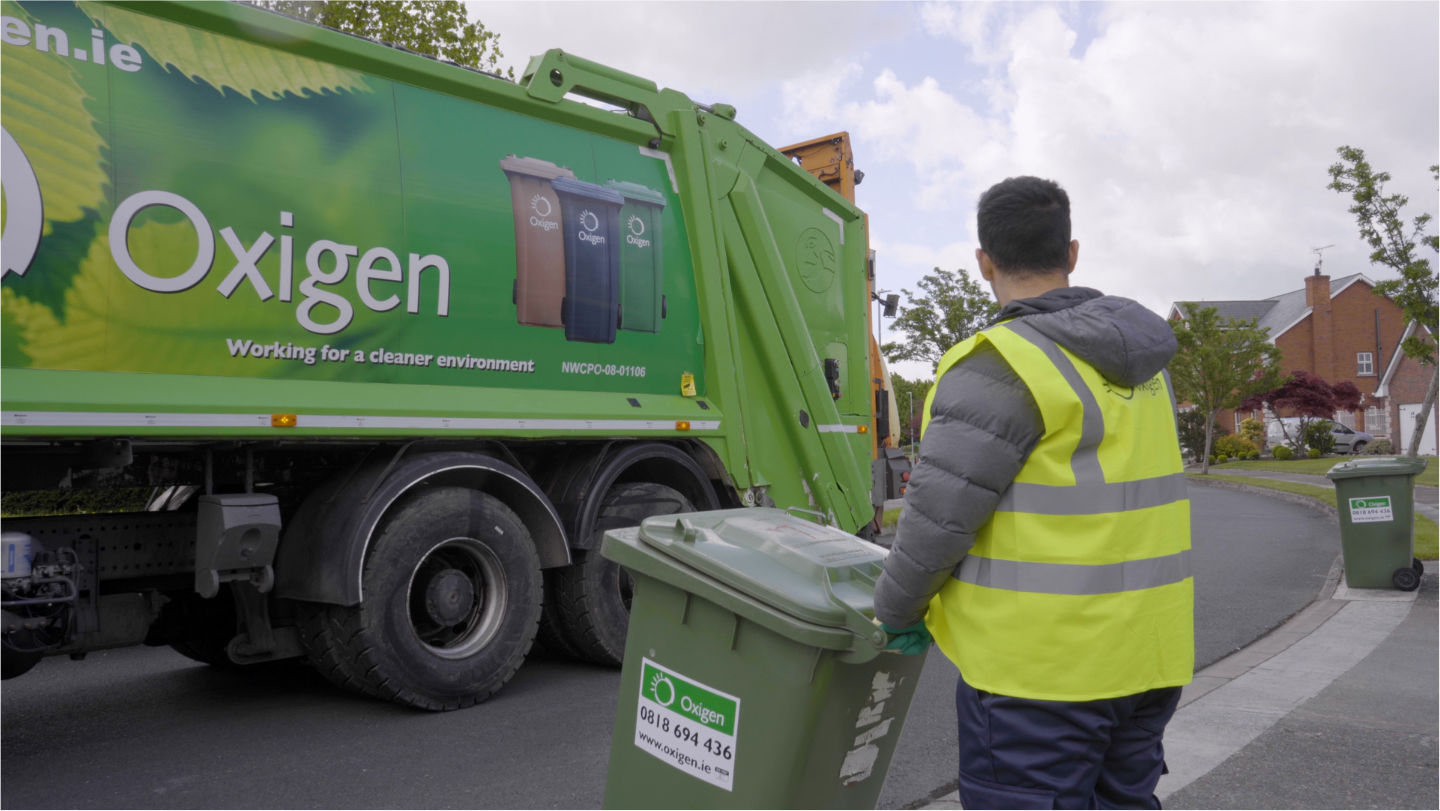 Waste collection lorry with operator and bins